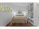 Bedroom features white walls, a queen-sized bed, and built-in shelving at 2706 Montgomery St, Durham, NC 27705