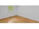 Empty bedroom featuring hardwood floors, white walls, and a window at 2706 Montgomery St, Durham, NC 27705