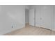 Bright bedroom featuring wood-look floors and a door to adjacent rooms at 2706 Montgomery St, Durham, NC 27705