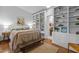Bedroom features built-in shelving, a queen-sized bed, and an ensuite bathroom at 2706 Montgomery St, Durham, NC 27705