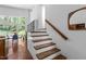Entryway view to an eat-in area and backyard through large windows, and staircase at 2706 Montgomery St, Durham, NC 27705