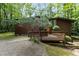 View of the house exterior, which features a wooden deck and uniquely styled trees in the yard at 2706 Montgomery St, Durham, NC 27705