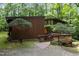 View of the house exterior, which features a wooden deck and uniquely styled trees in the yard at 2706 Montgomery St, Durham, NC 27705