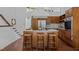 Well-lit kitchen with an island and counter seating, showcasing natural wood cabinets and stainless steel appliances at 2706 Montgomery St, Durham, NC 27705