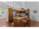 Bright kitchen features wood cabinets, center island with seating, and stainless steel appliances at 2706 Montgomery St, Durham, NC 27705