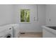 A bright laundry room features a Miele washer and dryer, a sink and a window to the outside at 2706 Montgomery St, Durham, NC 27705