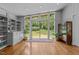 Bright living room with hardwood floors, shelving, and sliding glass doors leading to the outdoor area at 2706 Montgomery St, Durham, NC 27705