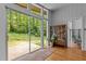 Bright living room with large sliding glass doors providing backyard views, hardwood floors, and a charming display cabinet at 2706 Montgomery St, Durham, NC 27705