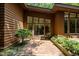 The house has a brick patio and surrounding landscaping that complements the wood exterior at 2706 Montgomery St, Durham, NC 27705