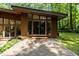 The house features a brick patio with steps leading to glass doors and large windows at 2706 Montgomery St, Durham, NC 27705