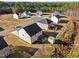 Aerial view of multiple houses and a cul-de-sac in a neighborhood surrounded by green trees and natural landscapes at 274 E Boulder Road Rd, Henderson, NC 27537