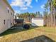 Backyard with a small shed, a pergola over a stone patio, and a partial view of the back of the house at 274 E Boulder Road Rd, Henderson, NC 27537