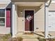 Charming townhouse with a red front door and a 'Merry Christmas' wreath at 274 E Boulder Road Rd, Henderson, NC 27537