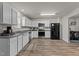 Open kitchen with white cabinets, stainless steel appliances, granite countertops and stylish flooring at 274 E Boulder Road Rd, Henderson, NC 27537