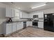 Modern kitchen featuring white cabinets, stainless appliances, and granite countertops at 274 E Boulder Road Rd, Henderson, NC 27537