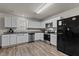 Well-lit kitchen featuring white cabinets, stainless appliances, and granite countertops at 274 E Boulder Road Rd, Henderson, NC 27537