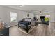 Spacious living room with wood flooring, large windows and two sofas at 274 E Boulder Road Rd, Henderson, NC 27537