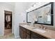 Bathroom features double vanity with granite countertop and a large mirror, with a walk-in closet nearby at 2801 Margots, Wake Forest, NC 27587