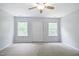 Neutral bedroom features carpet, ceiling fan and natural light from the windows and a double closet at 2801 Margots, Wake Forest, NC 27587