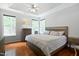 Bright bedroom features hardwood floors, a ceiling fan, and natural light from multiple windows at 2801 Margots, Wake Forest, NC 27587