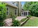 Back exterior of the home shows off lush landscaping, a private patio and the screened in porch at 2801 Margots, Wake Forest, NC 27587