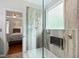 Modern tiled shower with glass door, seating, and natural light is located next to the primary bedroom at 2801 Margots, Wake Forest, NC 27587