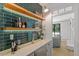 Contemporary bar area with tiled backsplash, floating wood shelves, and beverage refrigerator at 300 Bordeaux Ln, Cary, NC 27511