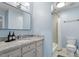 Contemporary bathroom featuring a gray vanity with granite counters and a walk-in shower at 300 Bordeaux Ln, Cary, NC 27511