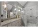 Bathroom features marble vanity, granite countertops, large frameless mirror and luxurious shower at 300 Bordeaux Ln, Cary, NC 27511