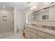Modern bathroom with dual sinks, a walk-in shower, and tiled floors at 300 Bordeaux Ln, Cary, NC 27511