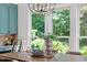 Sun-drenched breakfast nook with a view of the lush garden and stylish table decor at 300 Bordeaux Ln, Cary, NC 27511