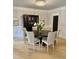 Elegant dining room featuring a round table with seating for six under a modern chandelier at 300 Bordeaux Ln, Cary, NC 27511