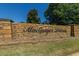 MacGregor Downs stone wall entrance with green lawn and plants below at 300 Bordeaux Ln, Cary, NC 27511