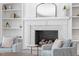 Living room fireplace with white brick and flanking built-in shelves at 300 Bordeaux Ln, Cary, NC 27511