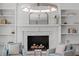 Close up of living room fireplace with white brick and flanking built-in shelves at 300 Bordeaux Ln, Cary, NC 27511