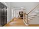 Bright foyer featuring hardwood floors, staircase and a dining room with modern decor at 300 Bordeaux Ln, Cary, NC 27511