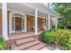 Inviting front porch with brick steps and columns leading to the beautiful front door at 300 Bordeaux Ln, Cary, NC 27511