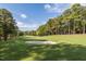 Scenic view of a well-maintained golf course with lush green grass and mature trees at 300 Bordeaux Ln, Cary, NC 27511