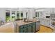Kitchen island featuring granite countertops, a sink, and views of the surrounding windows at 300 Bordeaux Ln, Cary, NC 27511