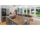 Spacious kitchen with a large island, stainless steel appliances, and bright natural light at 300 Bordeaux Ln, Cary, NC 27511