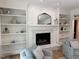 Cozy living room featuring a fireplace, built-in shelves, and comfortable seating for relaxation and entertainment at 300 Bordeaux Ln, Cary, NC 27511