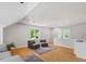 Bright living room with hardwood floors, natural light, and two comfortable gray chairs at 300 Bordeaux Ln, Cary, NC 27511