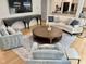 Bright living room boasts hardwood floors, stylish furniture, and large TV for relaxation and entertainment at 300 Bordeaux Ln, Cary, NC 27511