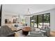 Inviting living room featuring large windows, fireplace, and open layout to the kitchen at 300 Bordeaux Ln, Cary, NC 27511