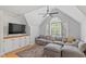 Comfortable living room featuring hardwood floors, a ceiling fan, and natural light at 300 Bordeaux Ln, Cary, NC 27511