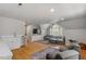 Open-concept living room with hardwood floors, vaulted ceilings, and a wet bar at 300 Bordeaux Ln, Cary, NC 27511