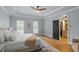 Well-lit main bedroom featuring a trey ceiling, ceiling fan, and hardwood floors at 300 Bordeaux Ln, Cary, NC 27511