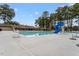 Community pool features a water slide, lifeguard chair, and clear blue water, surrounded by tall trees at 300 Bordeaux Ln, Cary, NC 27511