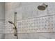Close up of the shower showing the dual shower heads and marble tile with accent border at 300 Bordeaux Ln, Cary, NC 27511