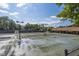 Wide angle of the community tennis court grounds, including lights and clubhouse at 300 Bordeaux Ln, Cary, NC 27511